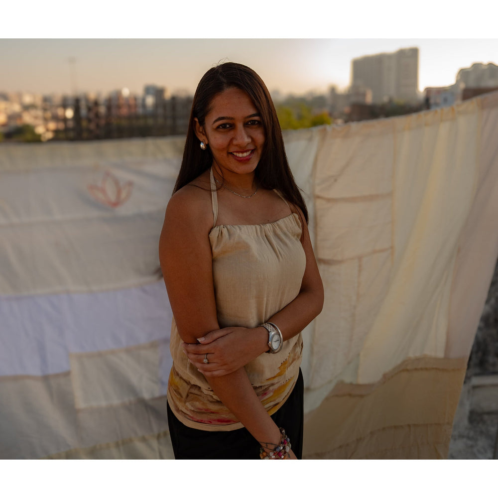 Beige sleeveless cotton top with abstract design accents, breathable summer top styled for casual daywear.