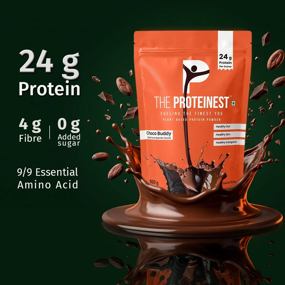 An orange stand-up pouch of The Proteinest Choco Buddy protein powder stands in a glossy chocolate splash on a dark green background, with floating chocolate pieces and text highlighting 24 g protein, 4 g fibre, 0 g added sugar, and 9/9 essential amino acid.