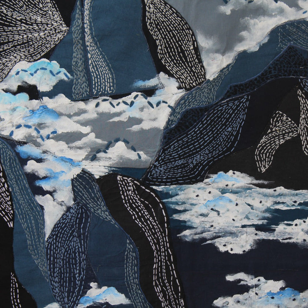 Kantha embroidery depicting mountains and cloud pattern on a dark background