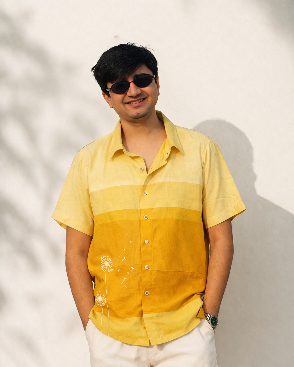 Man wearing a yellow and orange gradient shirt against a light background