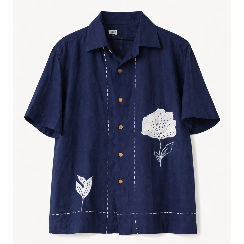 Navy blue shirt with white floral embroidery on a light gray background