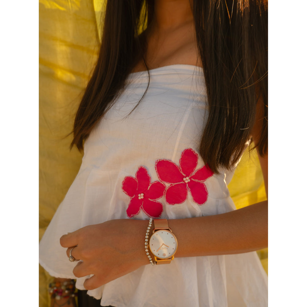 Woman wearing a minimal floral strapless cotton top with handmade flower accents, lightweight summer tube top.