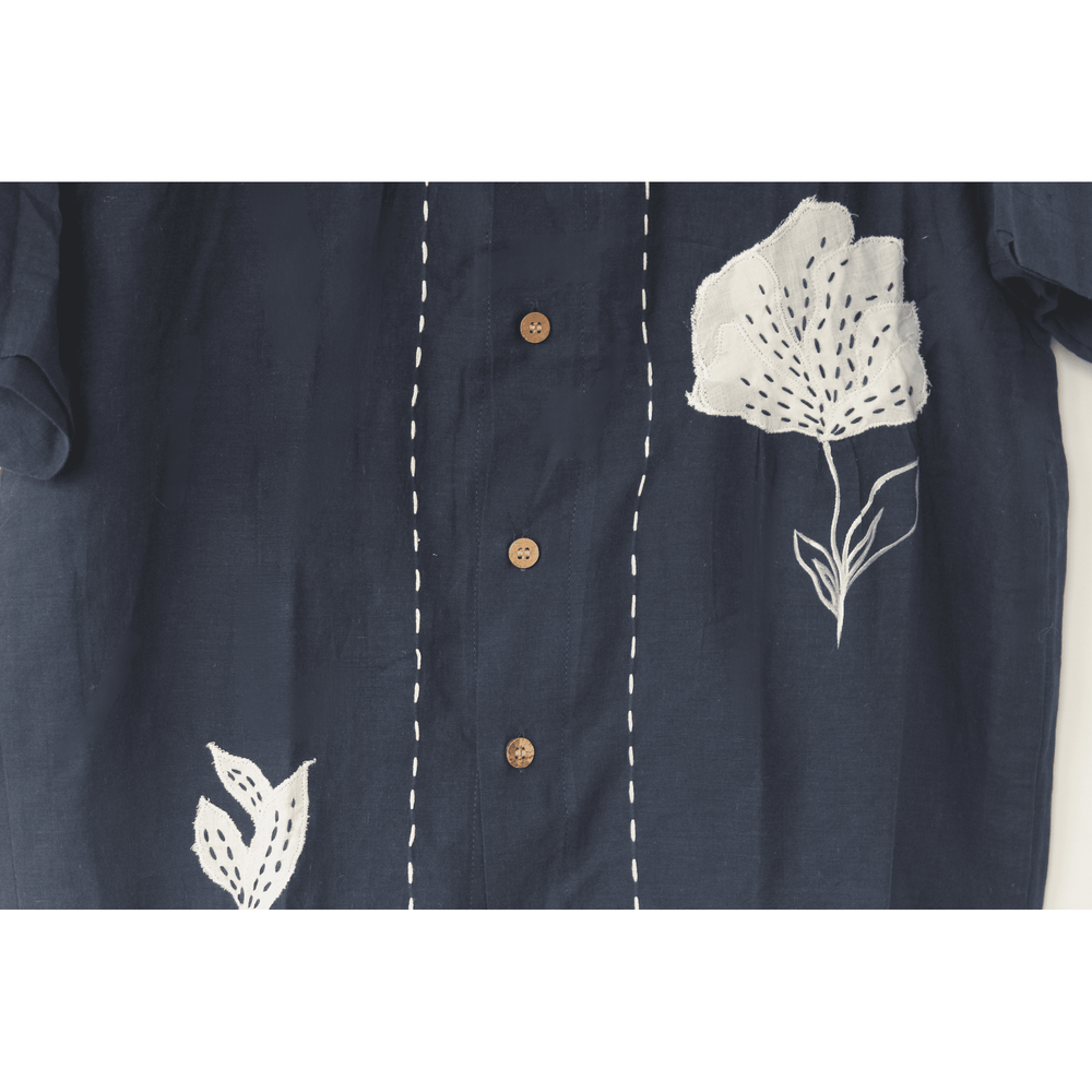Navy blue relaxed-fit cotton shirt by JOD with white hand-applique floral detail and wooden buttons