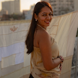 Beige sleeveless cotton summer top with subtle abstract artwork, comfortable top for casual outings and vacations.