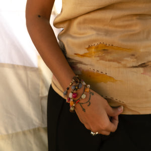 Beige cotton sleeveless top with abstract artwork detail, relaxed summer top for casual outfits and vacation styling.