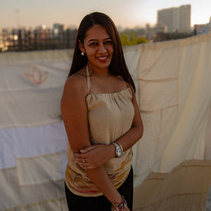 Beige sleeveless cotton top with abstract design accents, breathable summer top styled for casual daywear.