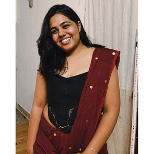 Black strapless corset blouse with gold detailing, styled as a saree blouse or party corset top for festive occasions.