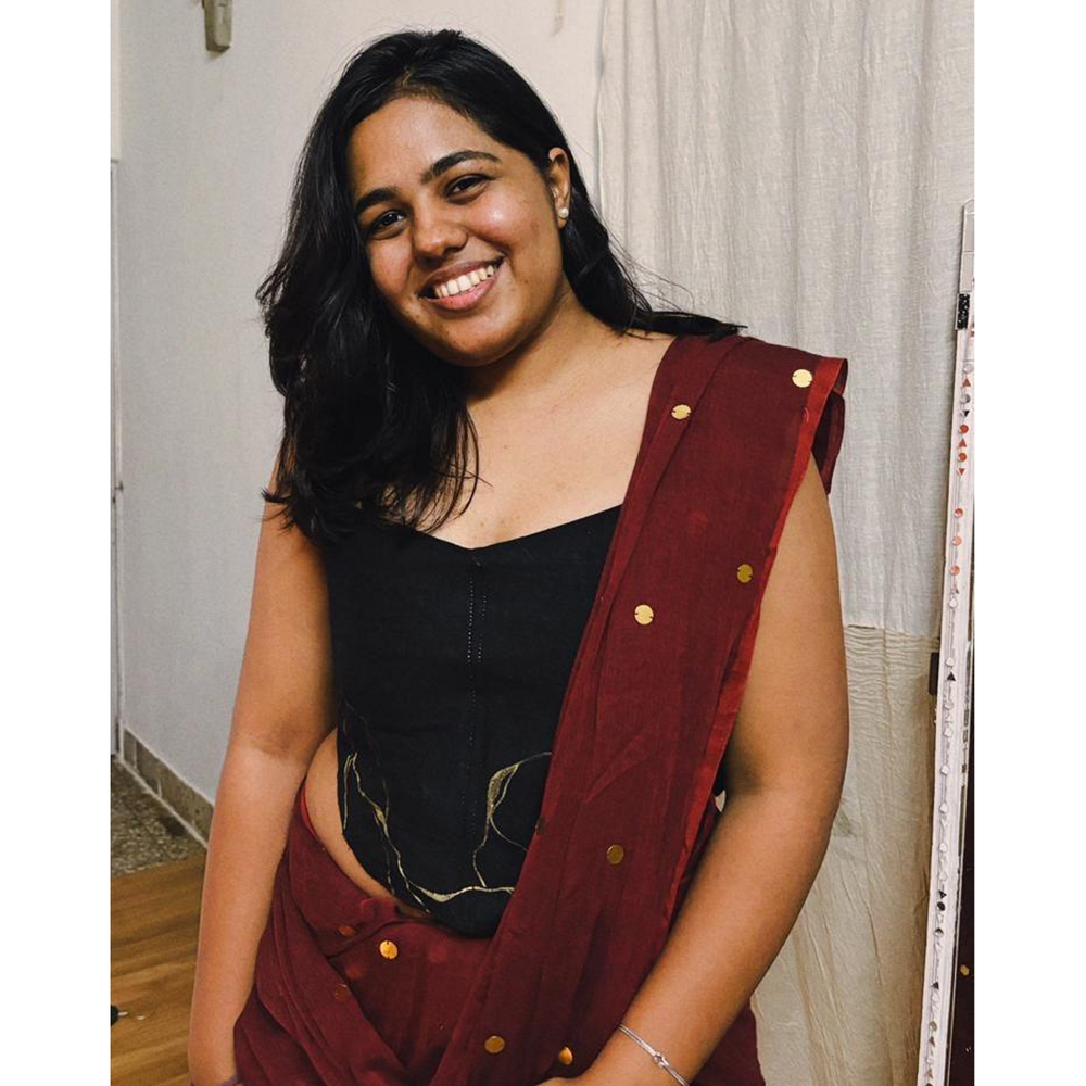 Black strapless corset blouse with gold detailing, styled as a saree blouse or party corset top for festive occasions.