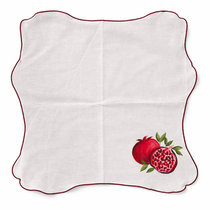 White napkin with red pomegranate design on a white background
