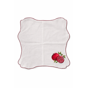 White napkin with red pomegranate design on a white background