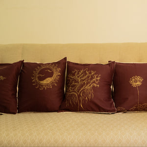 Beige sofa with decorative hand painted pillows and a small table