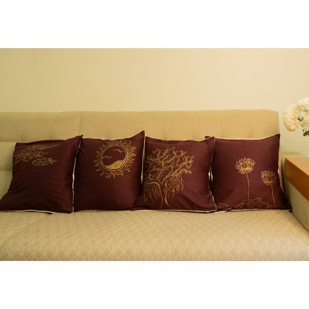Beige sofa with decorative hand painted pillows and a small table
