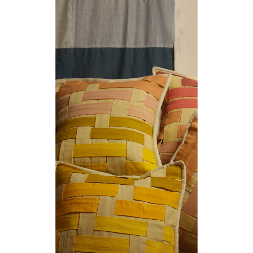 Decorative patchwork cushion covers by JOD in warm woven reclaimed textiles