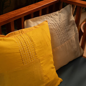 Yellow and beige pure cotton embroidered pillows on a wooden swing jhula