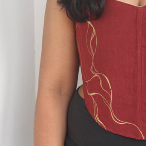 Red top with gold Painting on a plain background