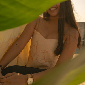 Peach corset with delicate floral embroidery, styled as a modern saree blouse or summer party corset top.
