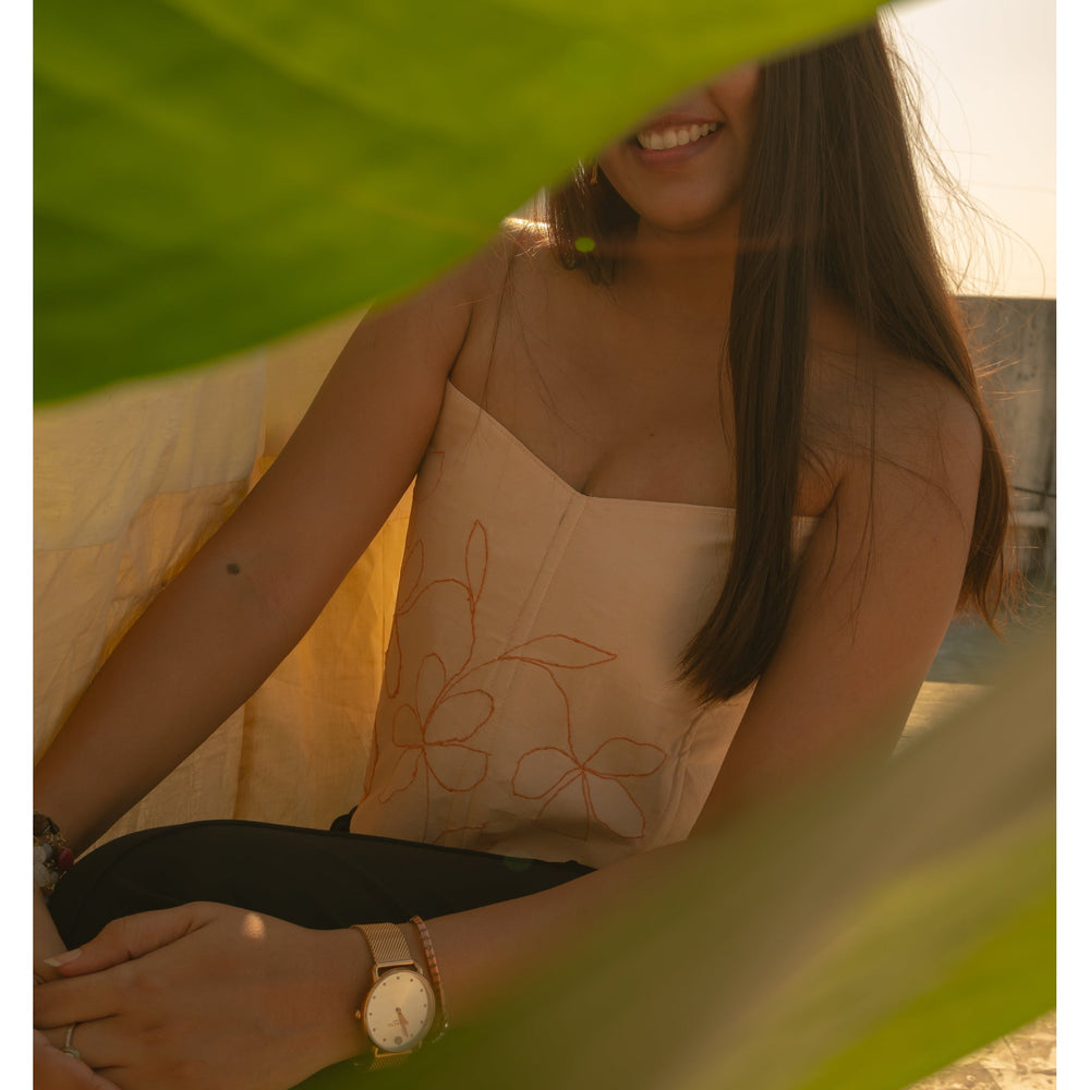 Peach corset with delicate floral embroidery, styled as a modern saree blouse or summer party corset top.