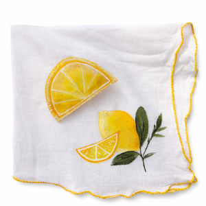 White handkerchief with hand painted yellow lemon slices and green leaves on a white background