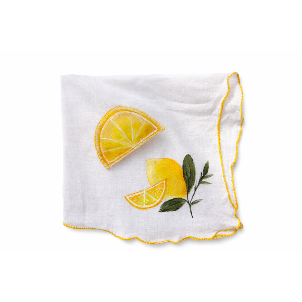White handkerchief with hand painted yellow lemon slices and green leaves on a white background