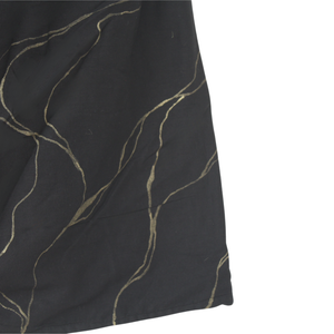 Close-up of a black top with gold thread patterns with golden
