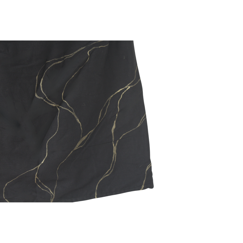 Close-up of a black top with gold thread patterns with golden