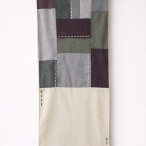 Handmade cotton patchwork table runner with neutral fabric panels and stitched detailing, table linen decor for dining tables and contemporary interiors.
