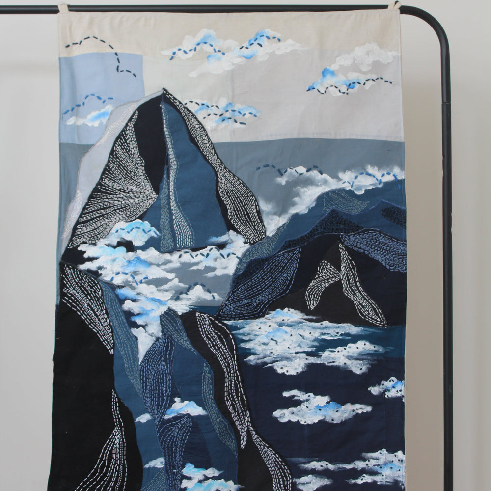 Large handcrafted textile wall art with layered landscape shapes and cloud textures, modern wall decor for living room interiors and workspaces.