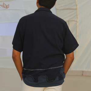Person wearing pure cotton vacation shirt with relaxed fit and minimal design, breathable summer shirt ideal for travel and holiday outfits.