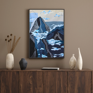 Framed mountain inspired artwork on a wall above a wooden cabinet with decorative vases.