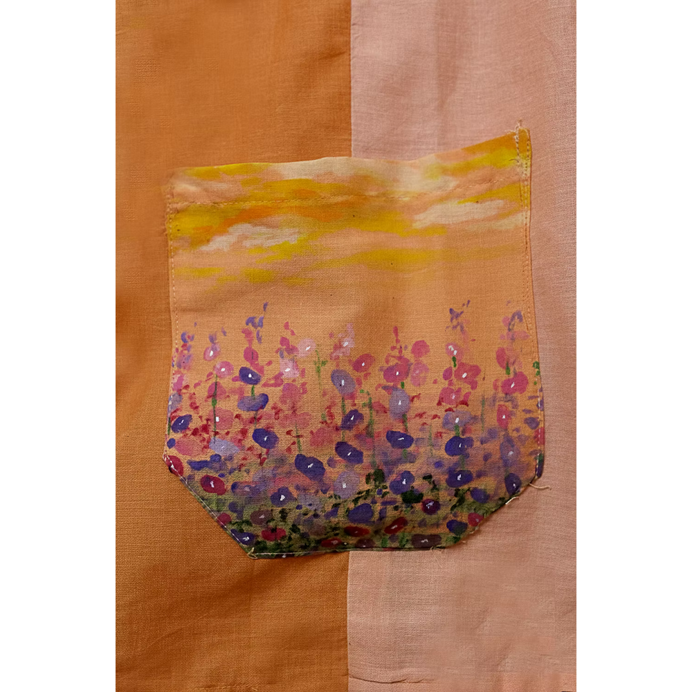 Close-up of hand-appliqued peach pocket artwork by JOD