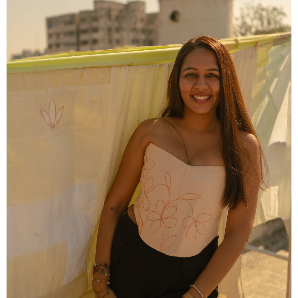 Strapless Peach corset top with minimal floral embroidery, stylish corset blouse for saree styling and evening wear.