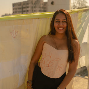 Strapless Peach corset top with minimal floral embroidery, stylish corset blouse for saree styling and evening wear.