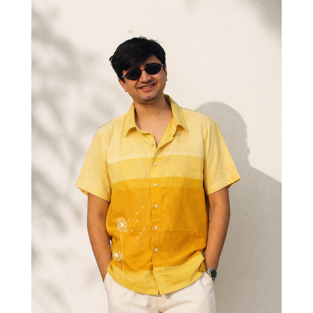 Man wearing a yellow and orange gradient shirt against a light background