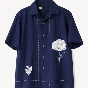 Navy blue shirt with white floral embroidery on a light gray background