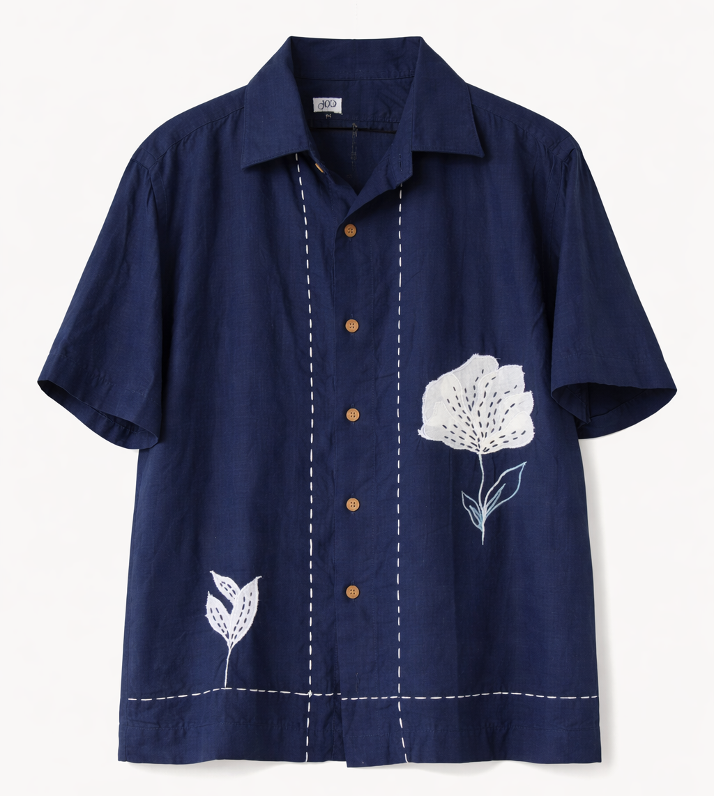 Navy blue shirt with white floral embroidery on a light gray background