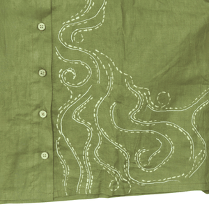 Green shirt with white embroidery on a white background