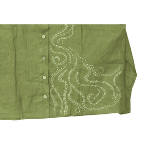 Green shirt with white embroidery on a white background