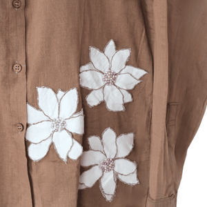 Brown shirt with white floral patterns, beaded details