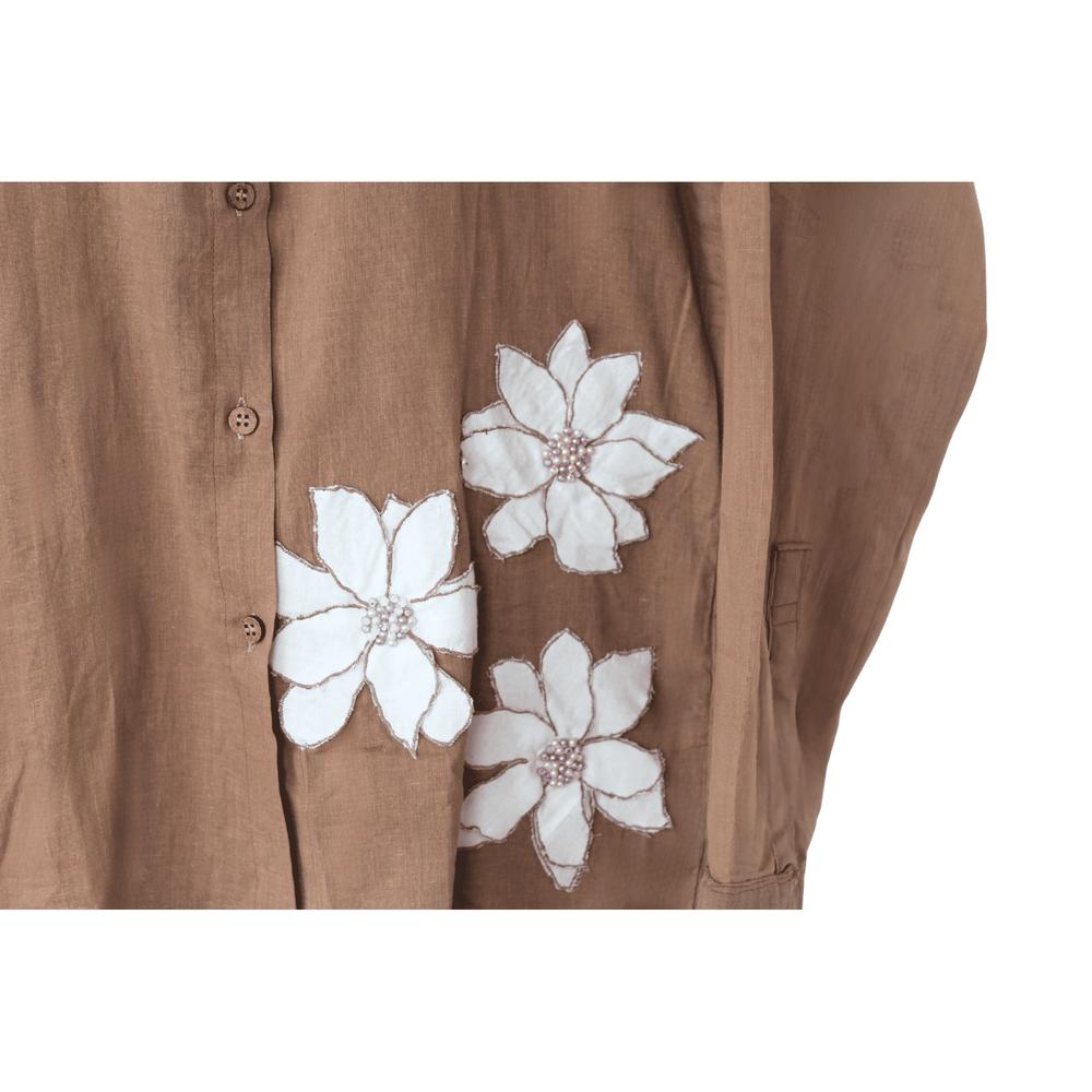 Brown shirt with white floral patterns, beaded details