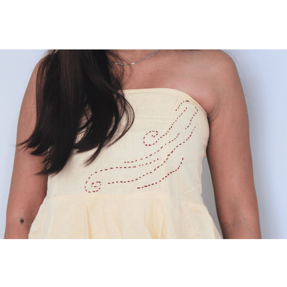 Light yellow strapless dress with red embroidery