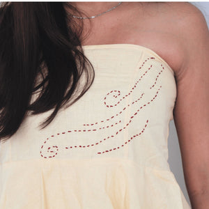 Light yellow strapless dress with red embroidery