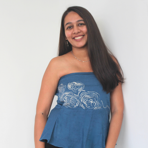Woman wearing a blue strapless top with white design 