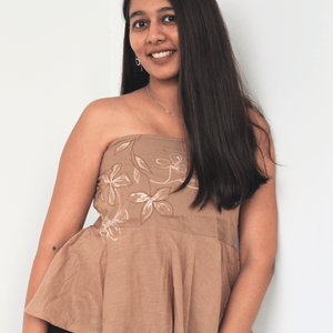 Woman wearing a pure cotton tube top for women with hand drawn artwork, breathable strapless summer top for casual and vacation wear.