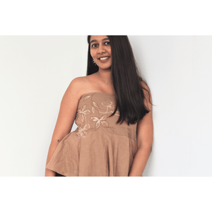 Woman wearing a pure cotton tube top for women with hand drawn artwork, breathable strapless summer top for casual and vacation wear.