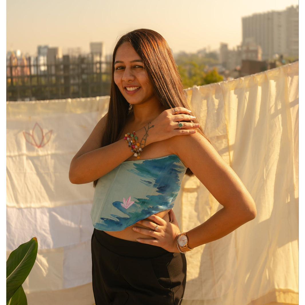 Woman wearing a strapless corset top with fitted silhouette and artistic detailing, modern corset top for evening styling.