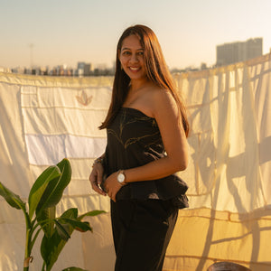 Woman wearing a strapless party wear dress with elegant detailing, stylish evening dress for women perfect for parties and special occasions.