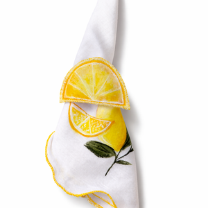 White napkin with lemon design napkin holder on a white background