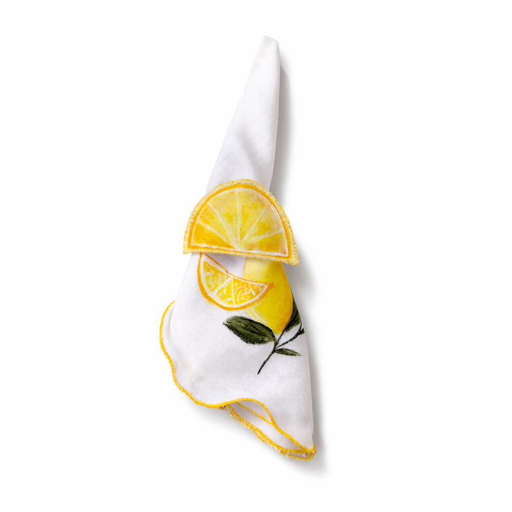 White napkin with lemon design napkin holder on a white background